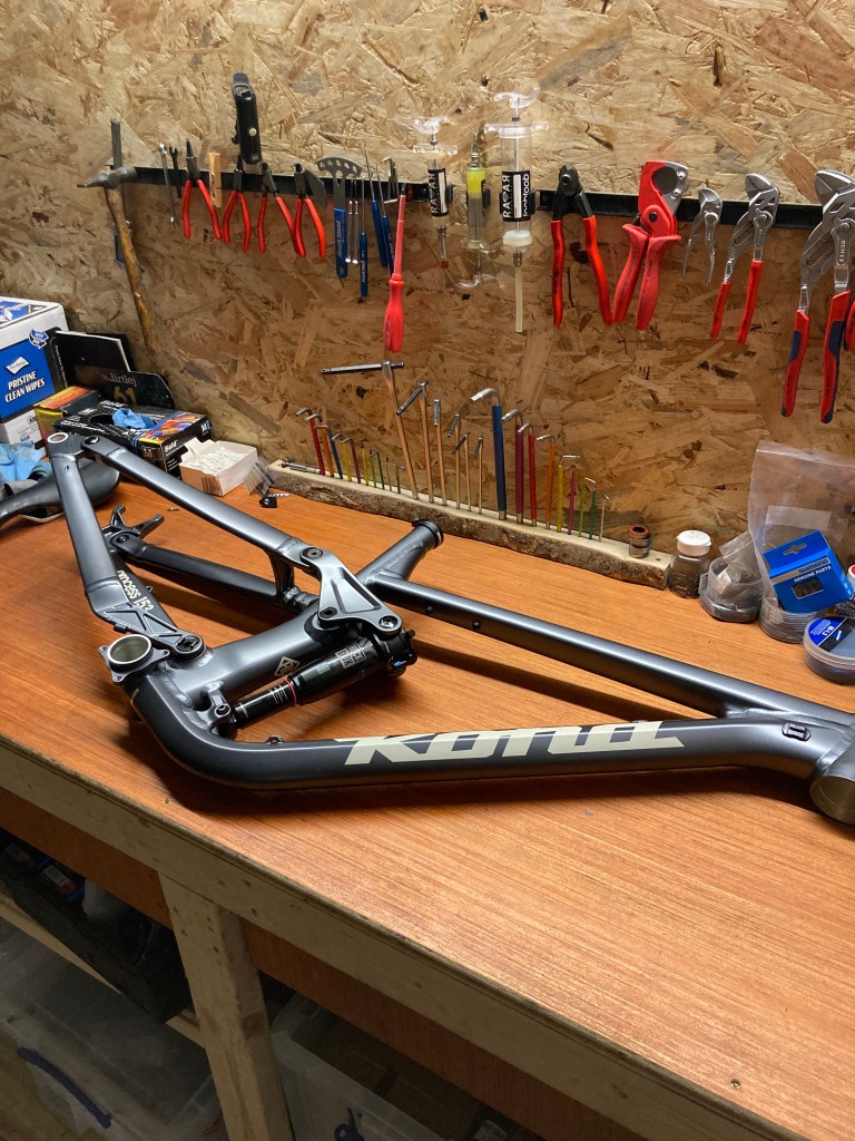 The frame has been stripped of its parts and ready for further disassembly and preparation for paint 